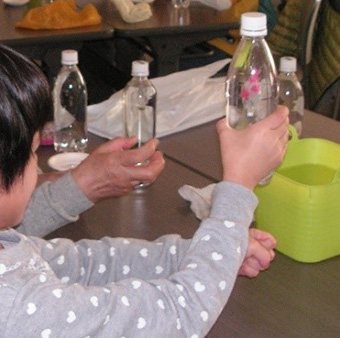 Participant at past event sends diver down with gentle squeeze of bottle